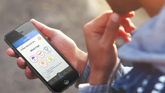 Photo of a young person using the quitSTART app.